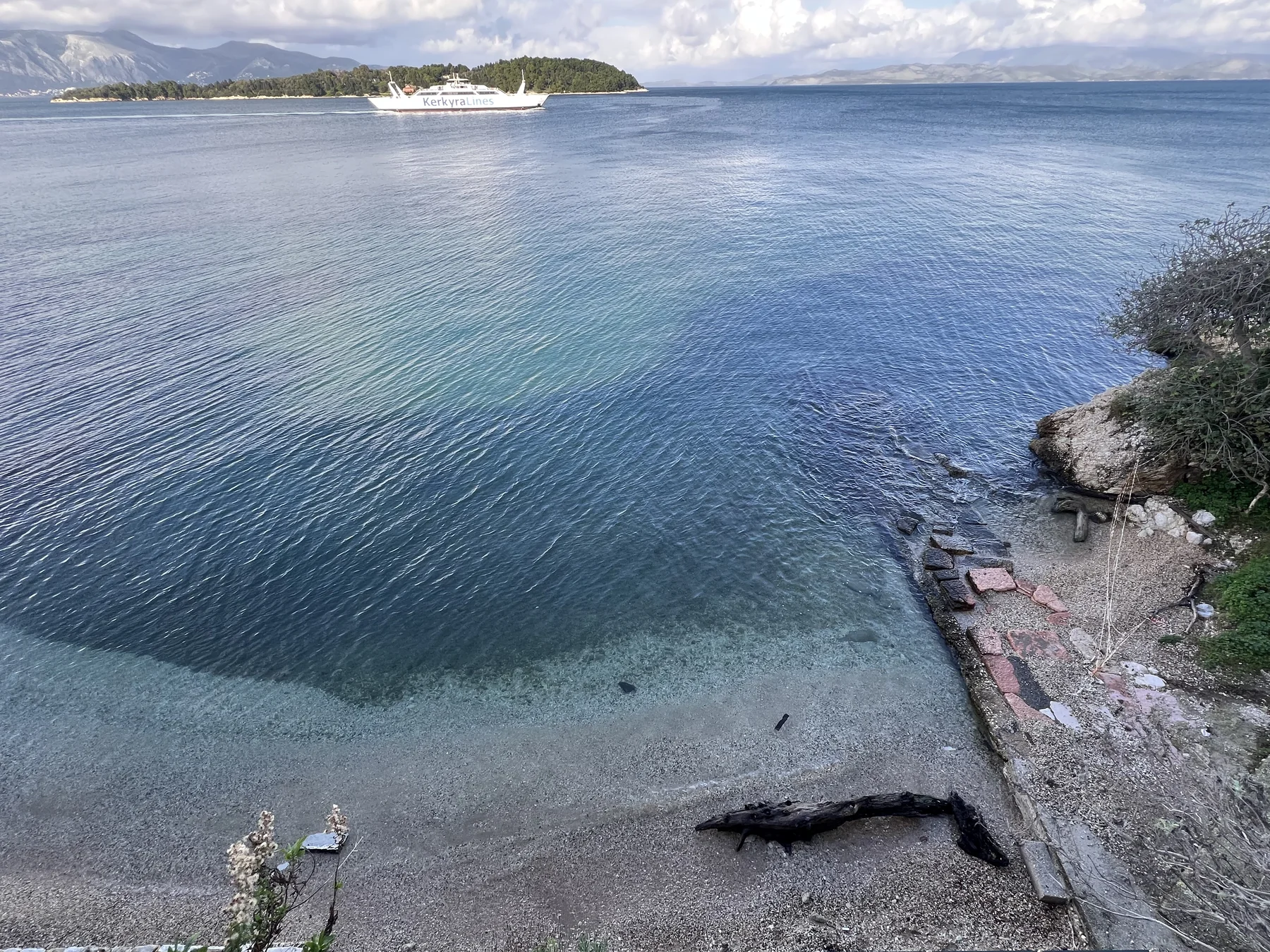 Sea view from Corfu coast, ferry on water, Albanian mountains in background