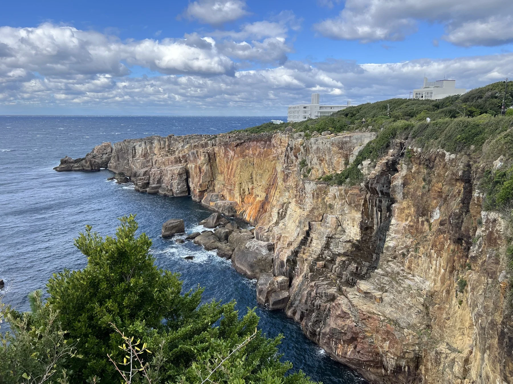 Coastal cliffs with ochre mineral staining, blue sea