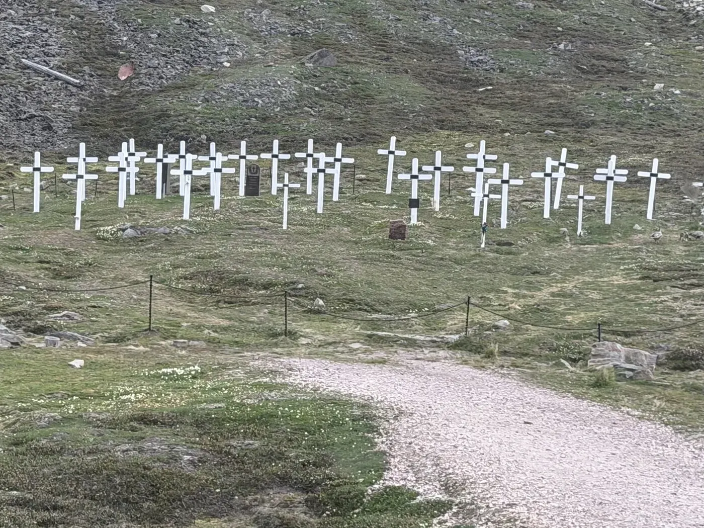 A hillside of white crosses — the Longyearbyen graveyard, roped off and closed